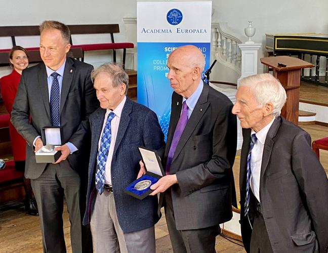 Sir Roger Penrose being awarded Academia Europaea’s Erasmus Medal and Gömböc. From left to right, Ambassador of Hungary to the United Kingdom, Ferenc Kumin; Sir Roger Penrose; Vice-President of Academia Europaea, Ole Petersen; Astronomer Royal, Lord Martin Rees